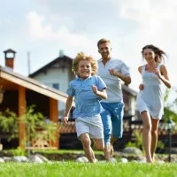 family running through lawn