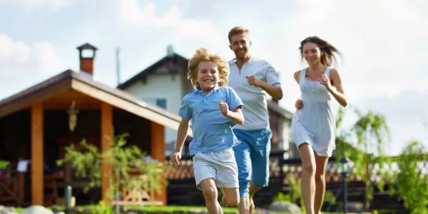 family running through lawn
